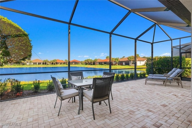 view of patio / terrace featuring a lanai and a water view