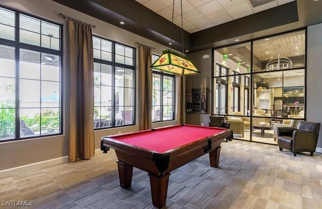 recreation room with a paneled ceiling, carpet flooring, pool table, and a wealth of natural light