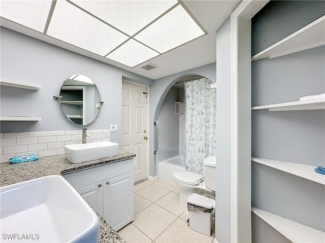 full bathroom featuring vanity, tile patterned floors, toilet, shower / bathtub combination with curtain, and tasteful backsplash