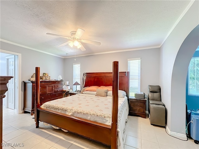 bedroom featuring a textured ceiling, crown molding, ceiling fan, and light tile patterned floors