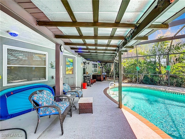 view of pool with a lanai and a patio area