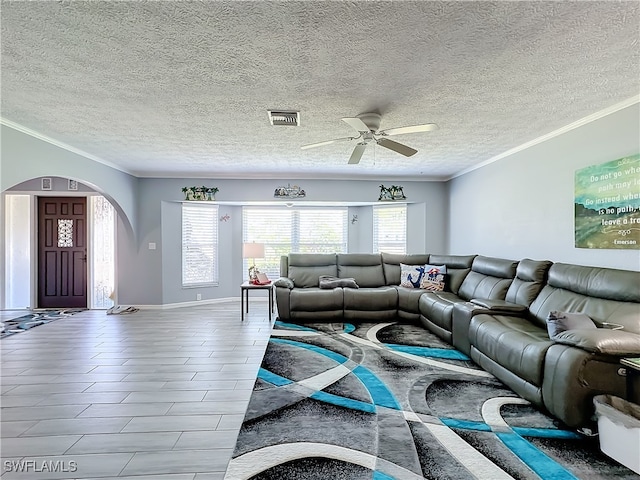 living room featuring ceiling fan, ornamental molding, and a textured ceiling