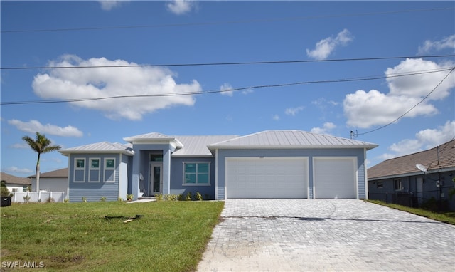 view of front of home featuring a front yard and a garage