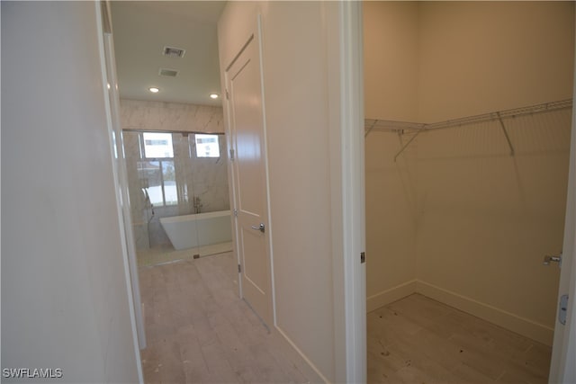 interior space featuring hardwood / wood-style flooring and a bath