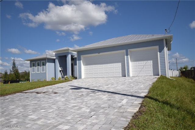 ranch-style house with a front yard and a garage