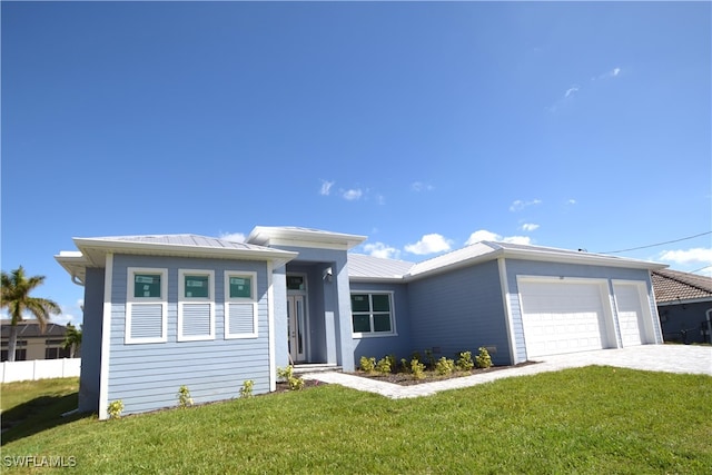 view of front of property with a front yard and a garage