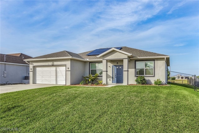 ranch-style house featuring a garage, a front lawn, and solar panels