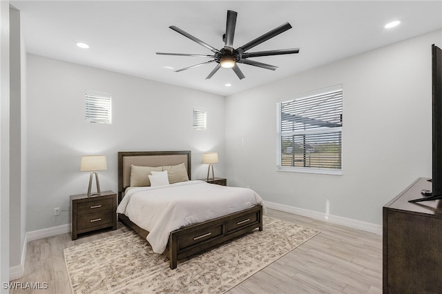 bedroom with light hardwood / wood-style flooring, multiple windows, and ceiling fan