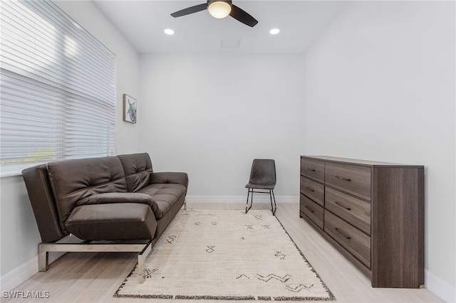 sitting room featuring light wood-type flooring and ceiling fan