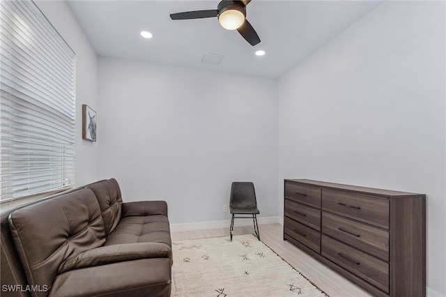 sitting room with light hardwood / wood-style floors and ceiling fan