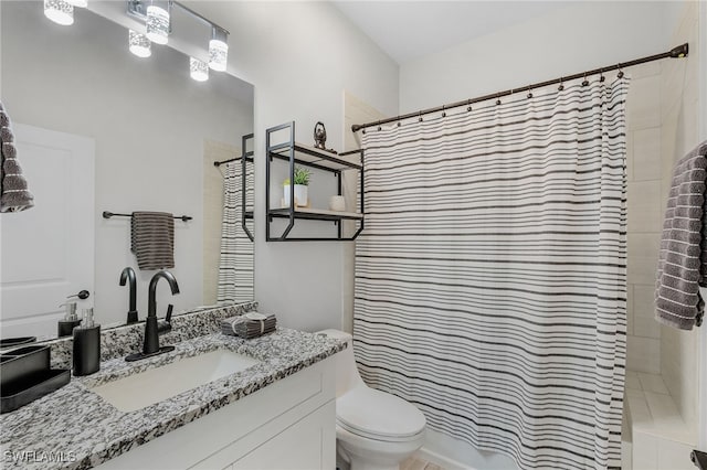 bathroom featuring vanity, toilet, and tile patterned flooring