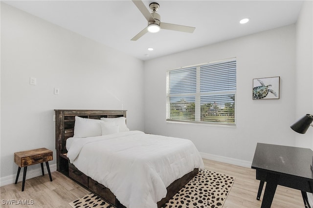 bedroom with ceiling fan and light wood-type flooring