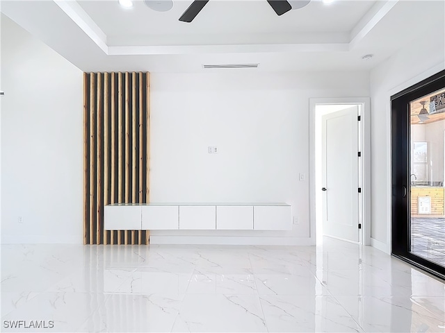 unfurnished room featuring a tray ceiling and ceiling fan