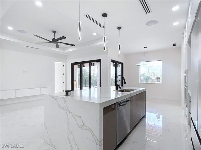 kitchen featuring dishwasher, a raised ceiling, sink, decorative light fixtures, and a large island