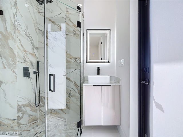 bathroom featuring vanity and an enclosed shower