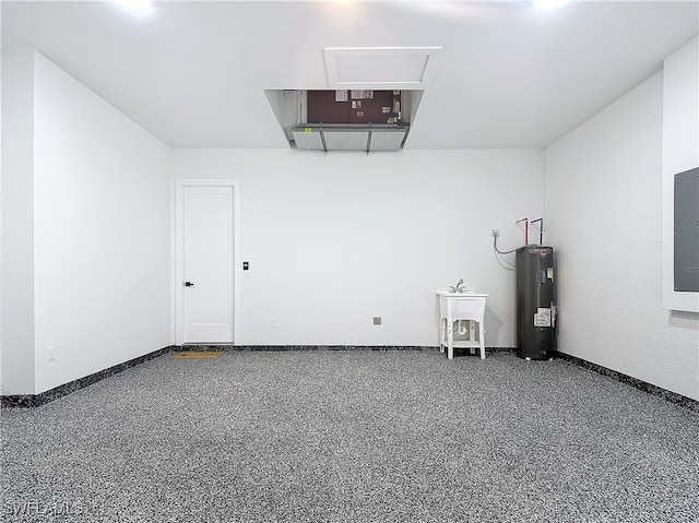 garage featuring electric water heater, sink, and electric panel