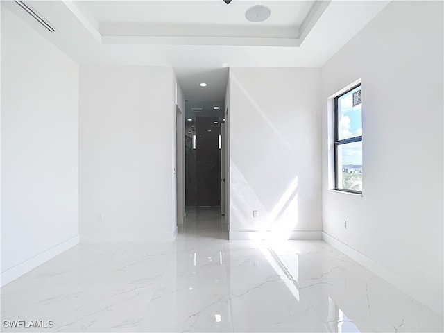 spare room featuring a tray ceiling