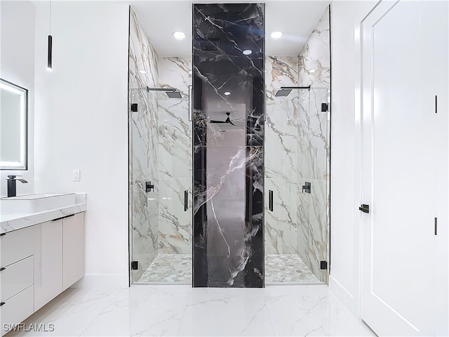 bathroom with vanity and a shower with door