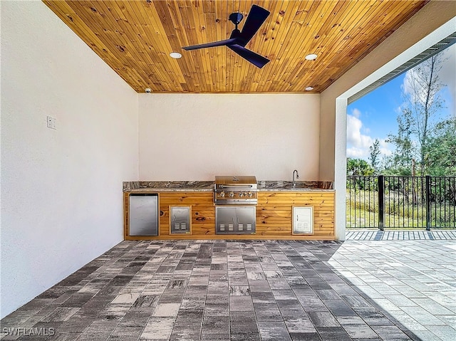 view of patio / terrace with a grill, ceiling fan, sink, and an outdoor kitchen