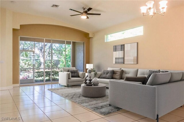 8771 Ibis Cove Cir, Naples, FL 34119 - living area with light tile patterned floors, ceiling fan with notable chandelier, visible vents, and baseboards