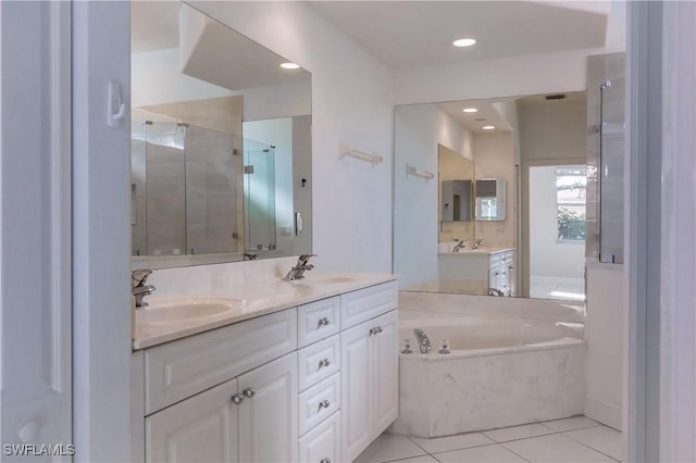 bathroom featuring tile patterned flooring, vanity, and shower with separate bathtub