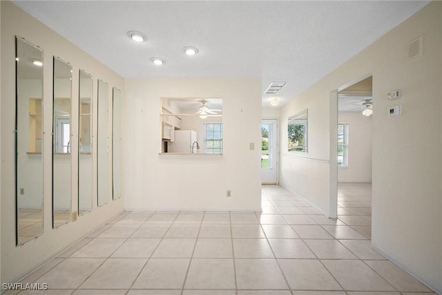 unfurnished room featuring ceiling fan and light tile patterned flooring