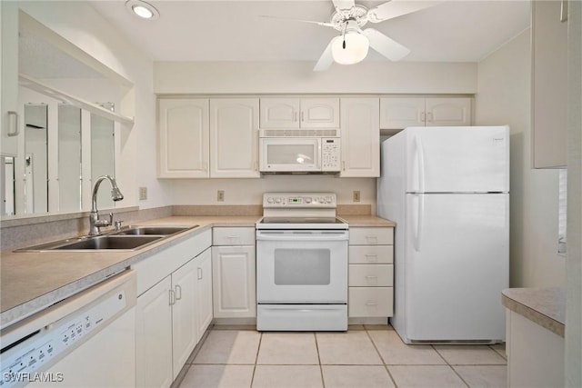 kitchen featuring white appliances, ceiling fan, sink, light tile patterned floors, and white cabinets