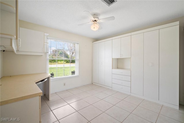 kitchen with white cabinetry, light tile patterned floors, a textured ceiling, and ceiling fan