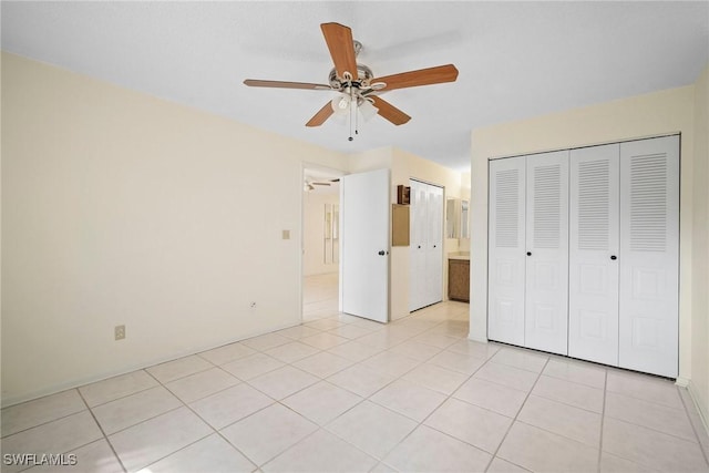 unfurnished bedroom featuring ceiling fan and light tile patterned flooring