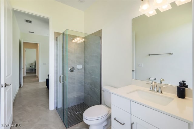 bathroom with vanity, a shower with shower door, and toilet