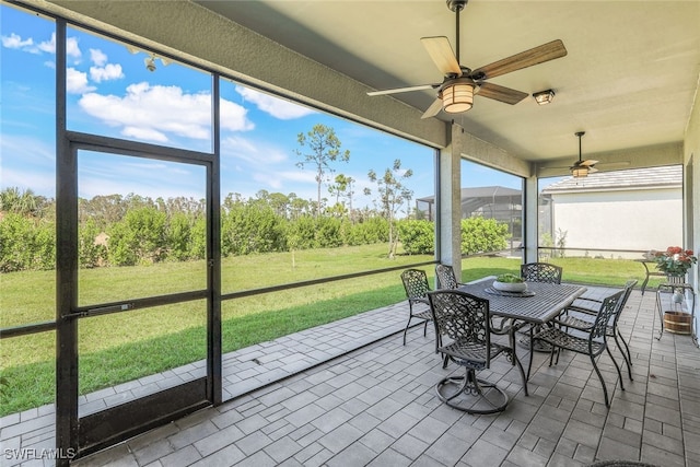 sunroom featuring ceiling fan