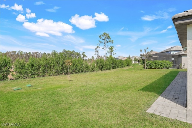 view of yard with a lanai