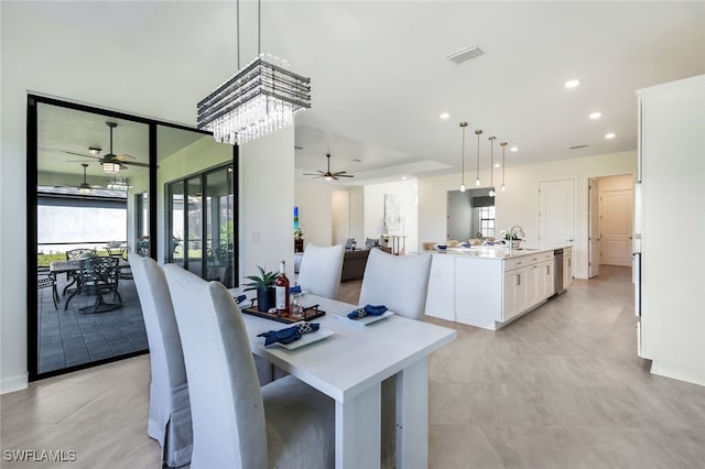 dining space with ceiling fan and sink