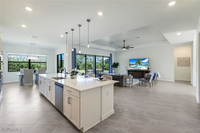 kitchen with a kitchen island with sink, stainless steel dishwasher, sink, and plenty of natural light