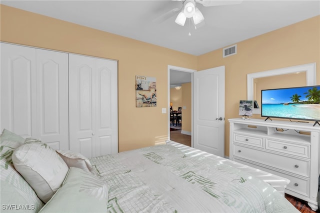 bedroom featuring ceiling fan, a closet, and dark wood-type flooring