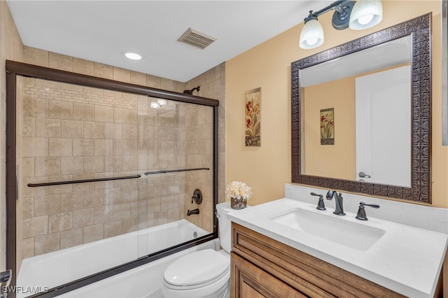 full bathroom featuring vanity, toilet, and enclosed tub / shower combo