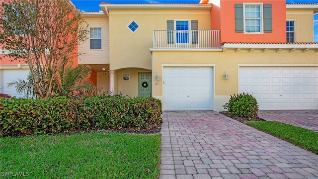 multi unit property featuring a garage and a balcony