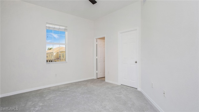 empty room featuring light carpet and ceiling fan