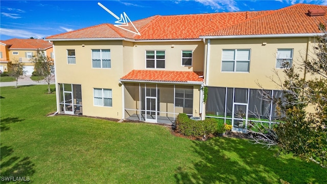 rear view of house featuring a lawn