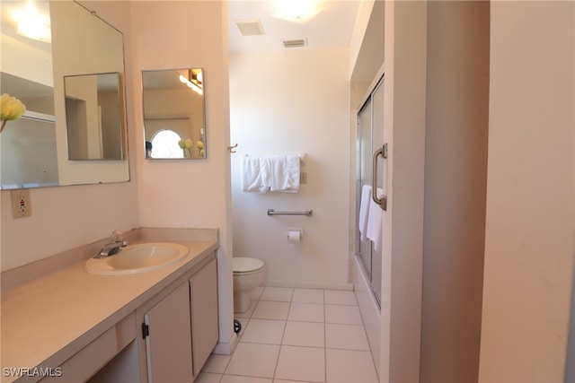 bathroom with toilet, an enclosed shower, vanity, and tile patterned flooring