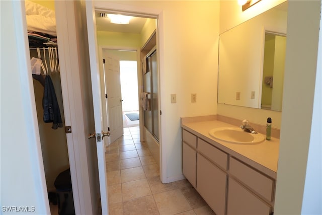 bathroom featuring vanity, an enclosed shower, and tile patterned floors