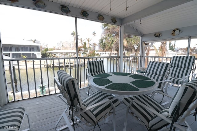 wooden terrace featuring a water view