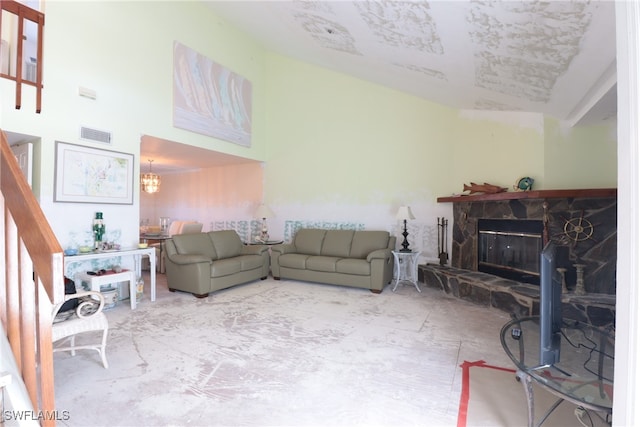 living room featuring a chandelier and a fireplace