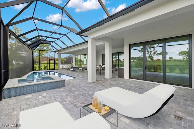 view of patio / terrace featuring outdoor lounge area, glass enclosure, and an in ground hot tub