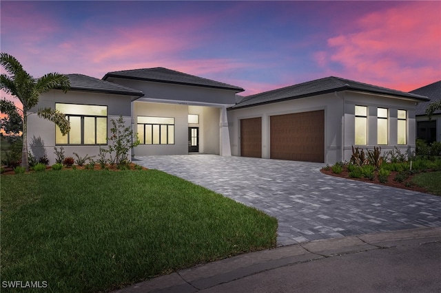 view of front of house with a yard and a garage