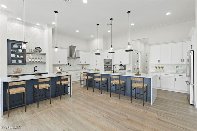 kitchen featuring a spacious island, a kitchen bar, hanging light fixtures, and appliances with stainless steel finishes