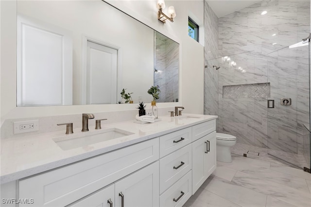 bathroom featuring a shower with door, vanity, and toilet