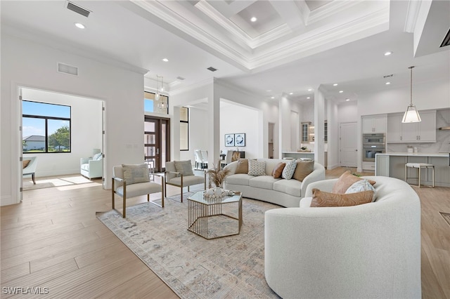 living room featuring coffered ceiling, light wood-type flooring, ornamental molding, a towering ceiling, and beamed ceiling