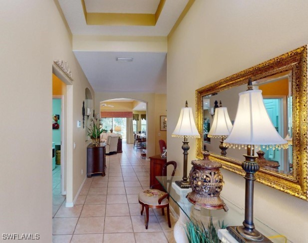5291 Laurel Oak Ct, North Port, FL 34287 - hall with visible vents, arched walkways, and light tile patterned floors