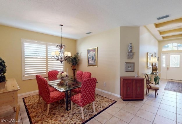 tiled dining area with a notable chandelier